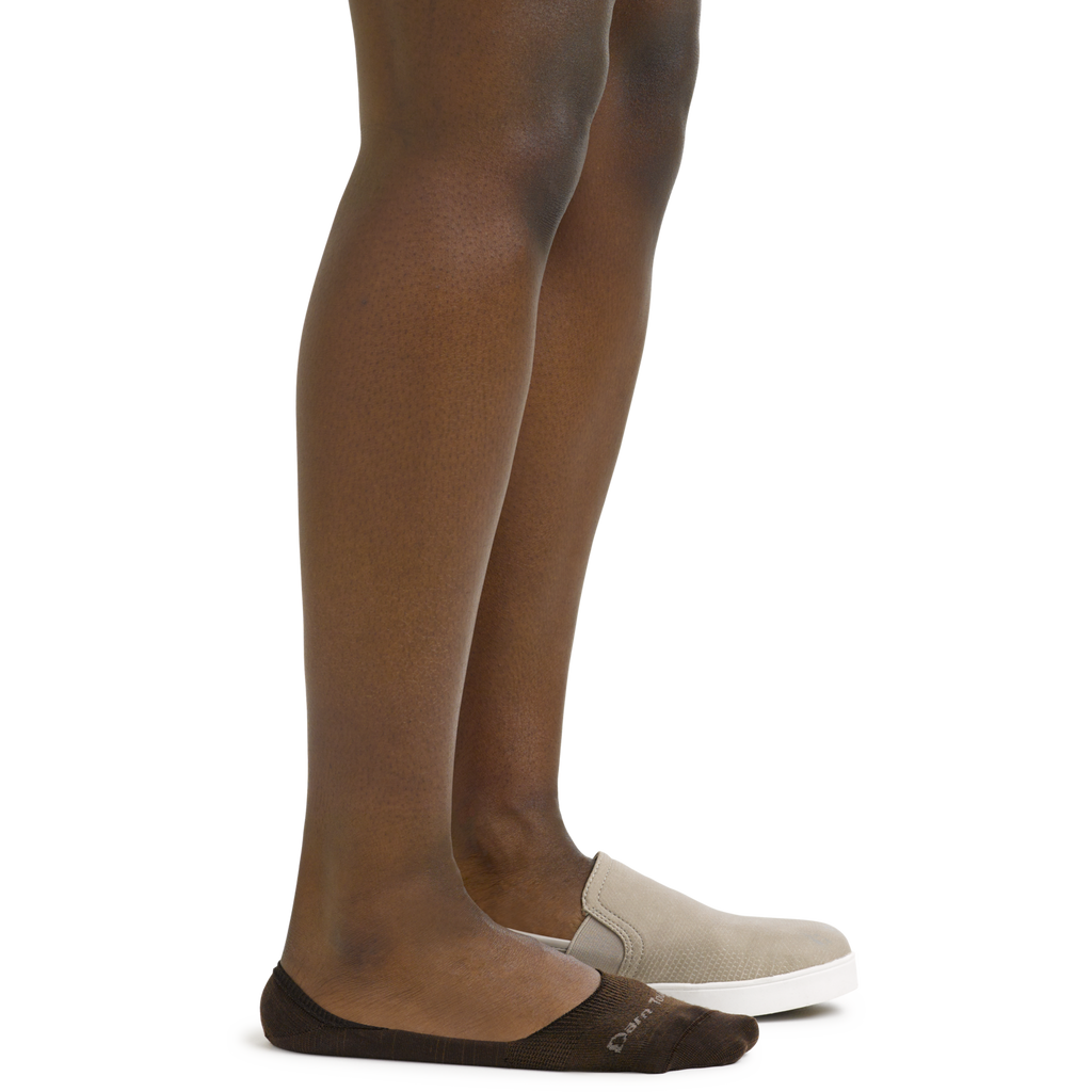 Side view of model wearing dark brown no-show socks with beige slip-on shoes