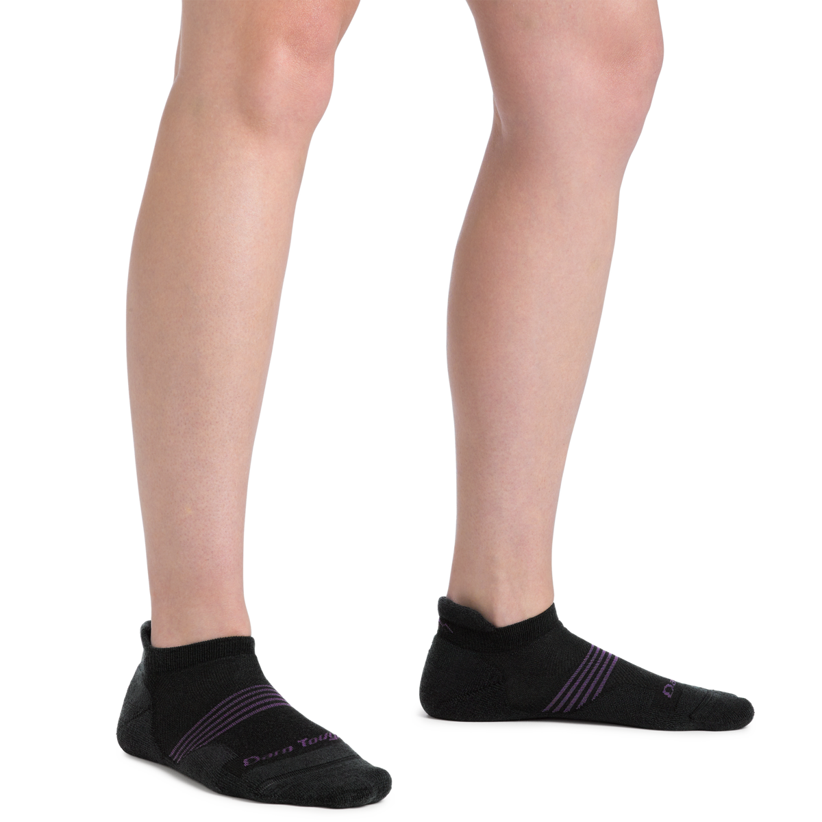 Woman wearing black Darn Tough no-show tab socks with purple accent stripes, side view