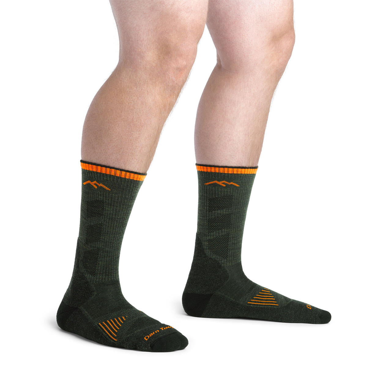 Model wearing Darn Tough men's boot hiking socks with orange mountain logo and striped cuff