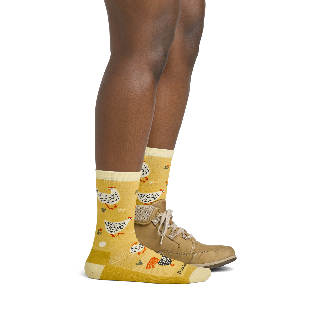 Woman wearing yellow crew socks with chicken pattern paired with tan lace-up shoes