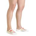 Woman wearing white floral no-show socks with pink and yellow flower pattern on feet