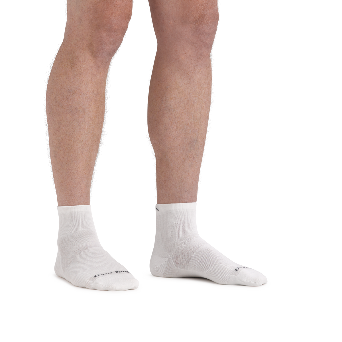 Model wearing Darn Tough quarter-length running socks shown from knees down on both feet