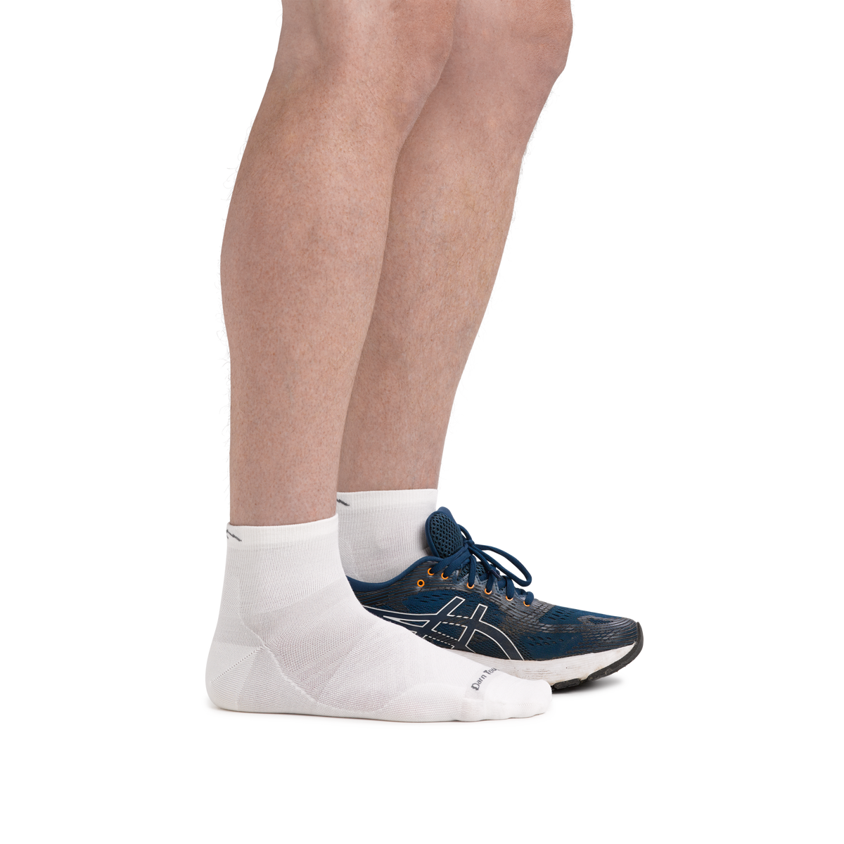 Model wearing white Darn Tough quarter-length running socks with blue ASICS sneakers, side view