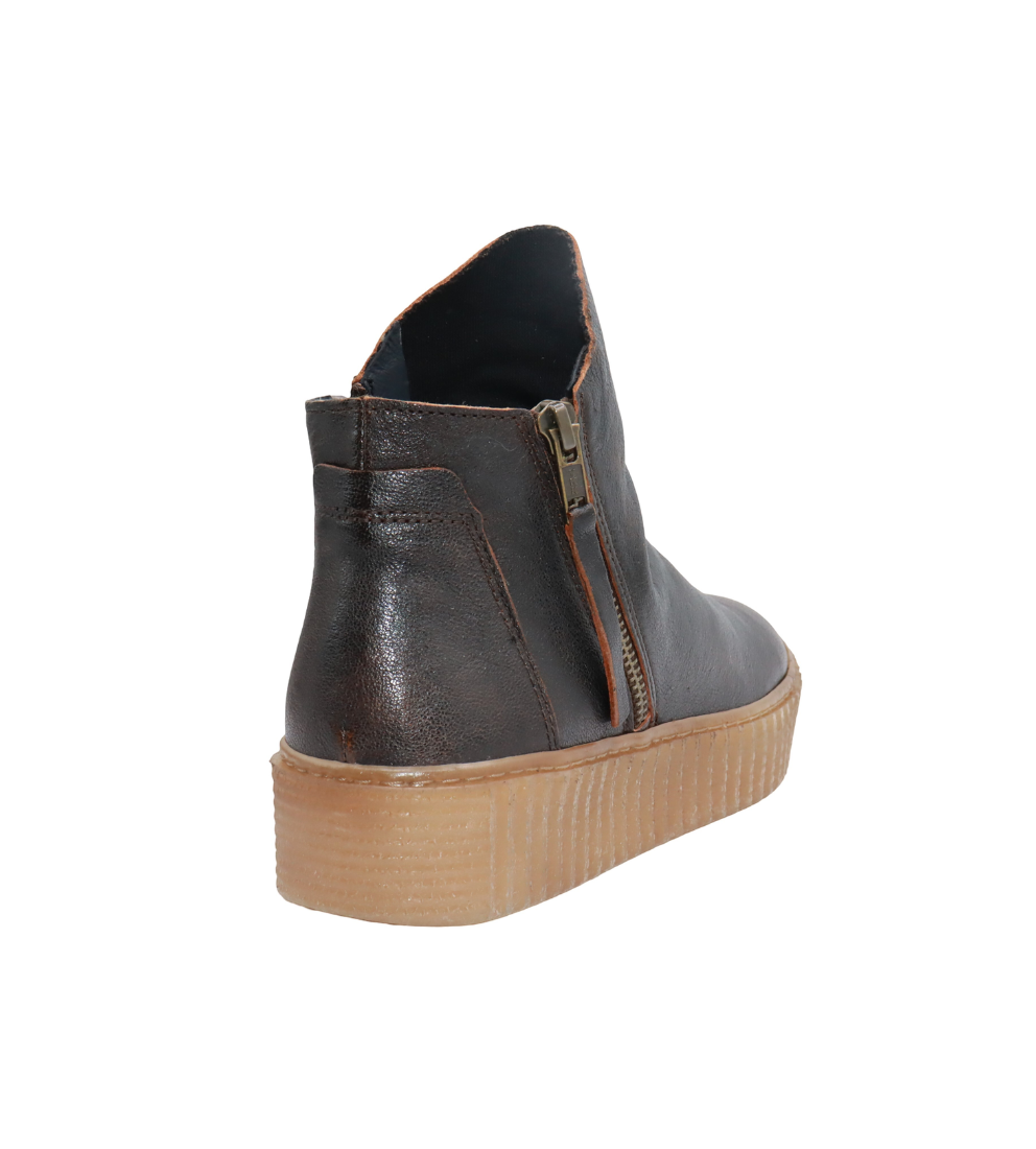 Back view of a leather ankle boot with side zipper and chunky tan platform sole