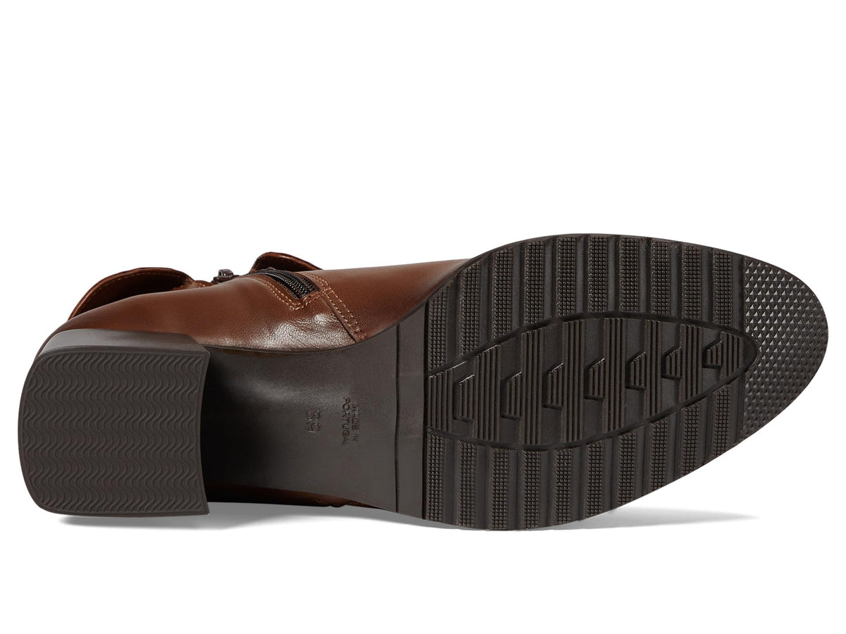 Bottom sole view of a women's leather boot showing tread pattern and block heel