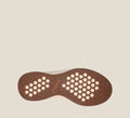 Taos shoe bottom sole in brown with hexagonal grip pattern, white cutouts