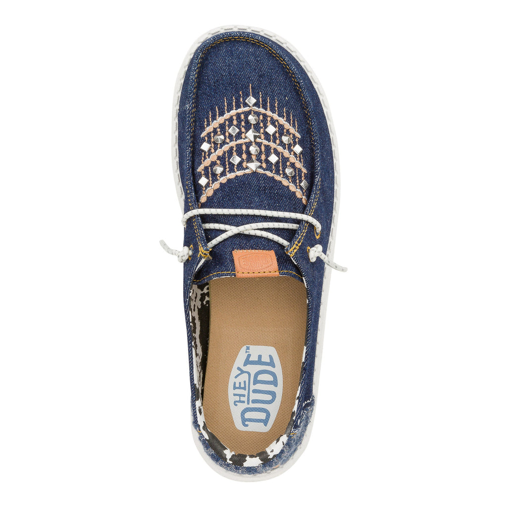 Hey Dude Wendy slip-on shoe with denim upper, studded embroidery, and rope laces
