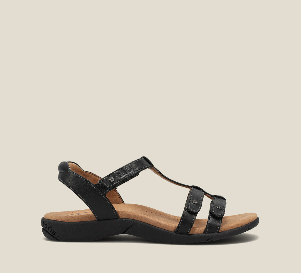 Taos Trophy 2 black leather T-strap sandal with adjustable straps and tan footbed