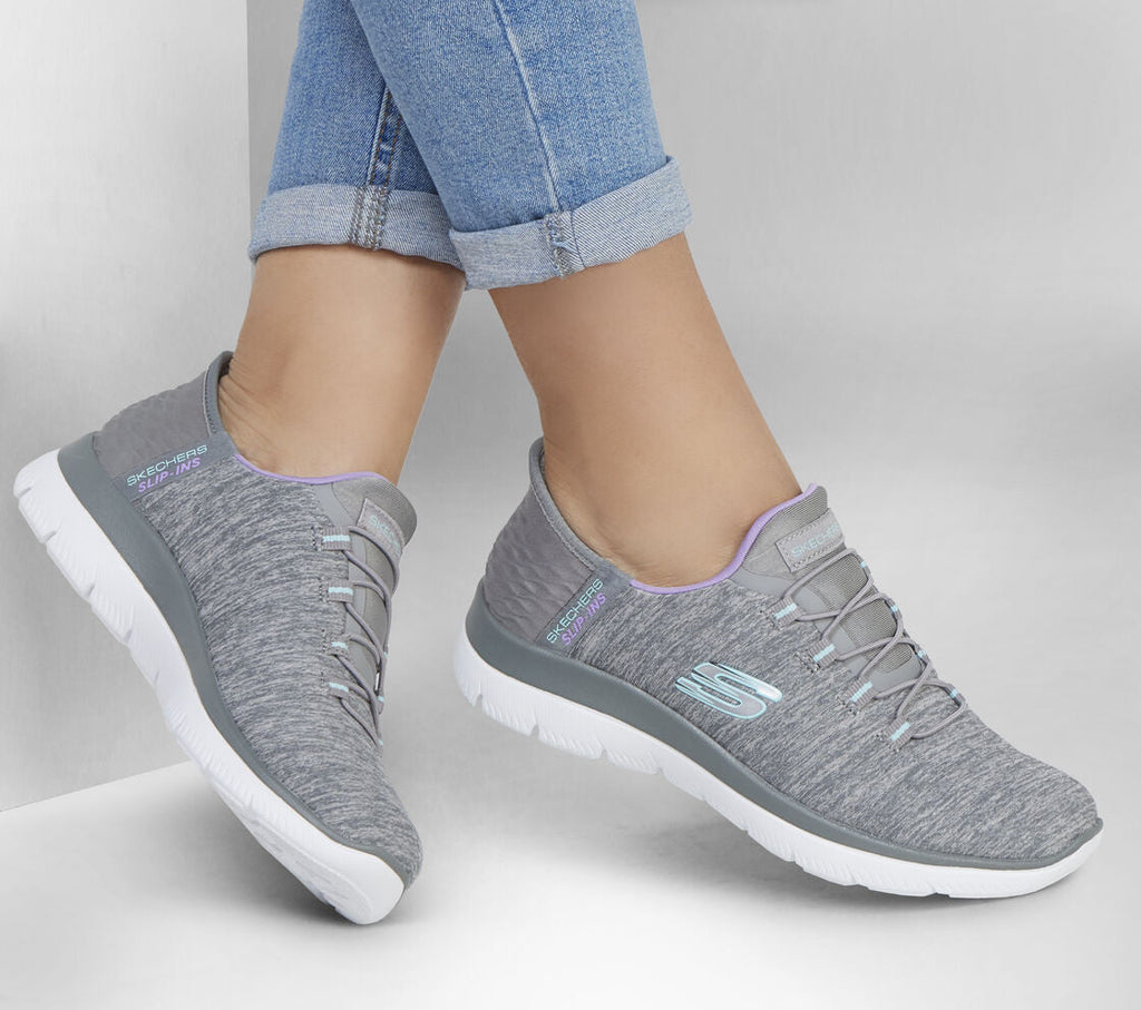 Skechers gray slip-in sneakers with lavender trim and white sole on woman's feet
