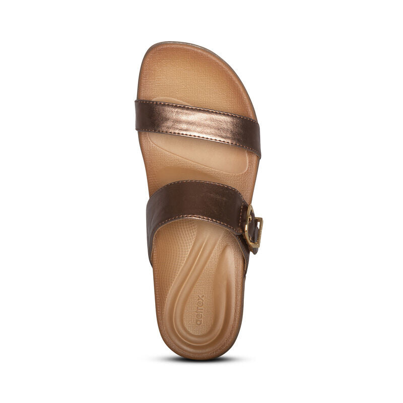 Women's slide sandal featuring dual metallic straps with adjustable buckle closure and contoured footbed