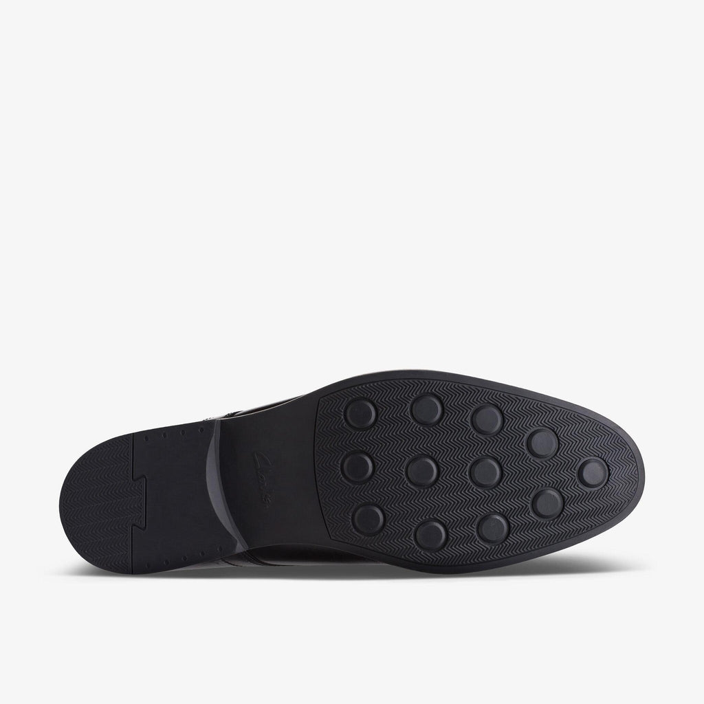 Bottom sole view of Clarks Whiddon Cap Leather mens dress shoe showing traction pattern