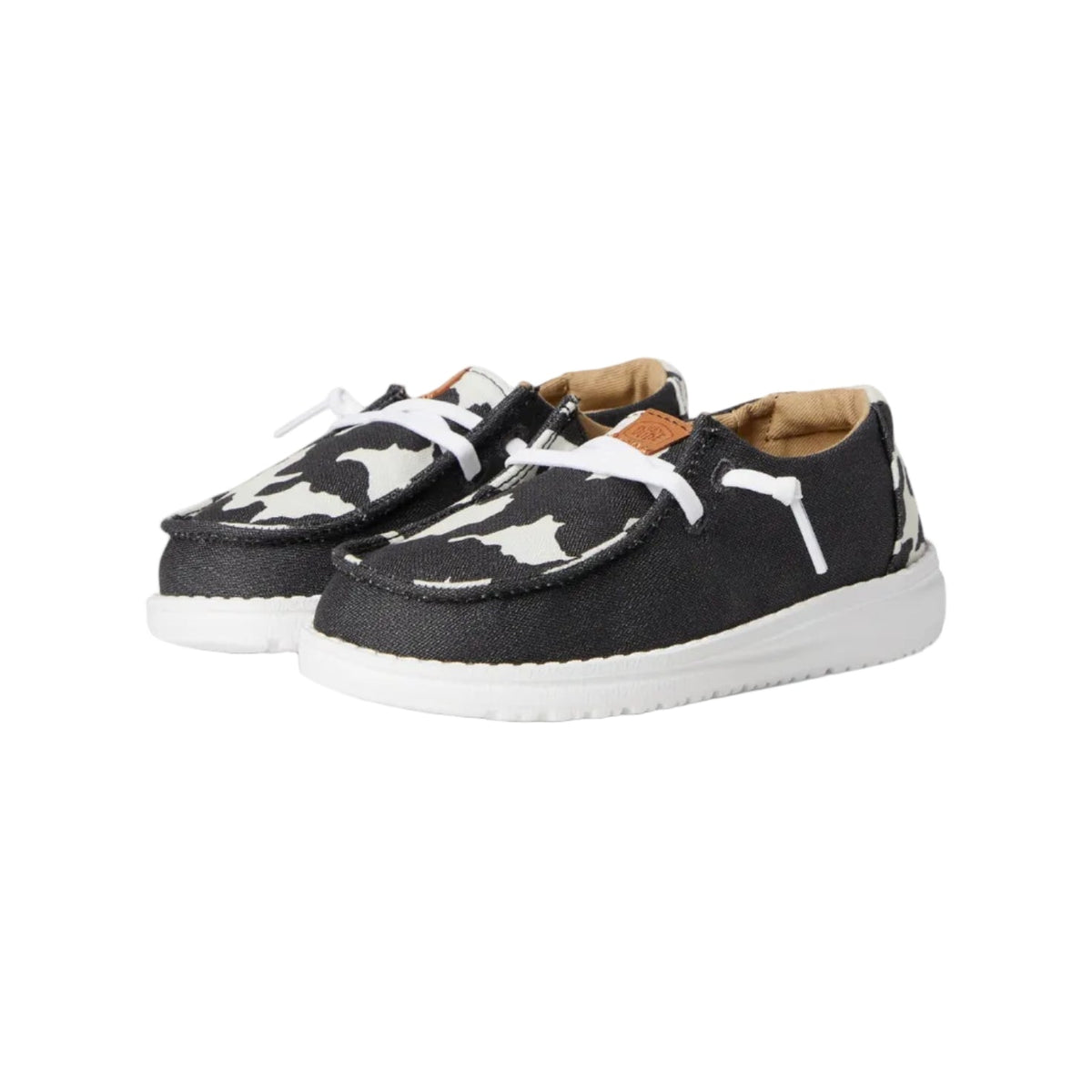 Hey Dude toddler slip-on shoes with cow print upper and white sole, pair view