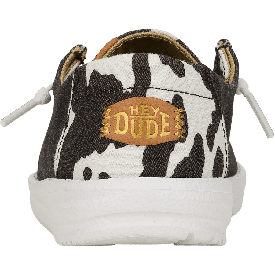 Hey Dude Girls Youth Wendy shoe rear view showing cow print canvas upper and brand logo patch