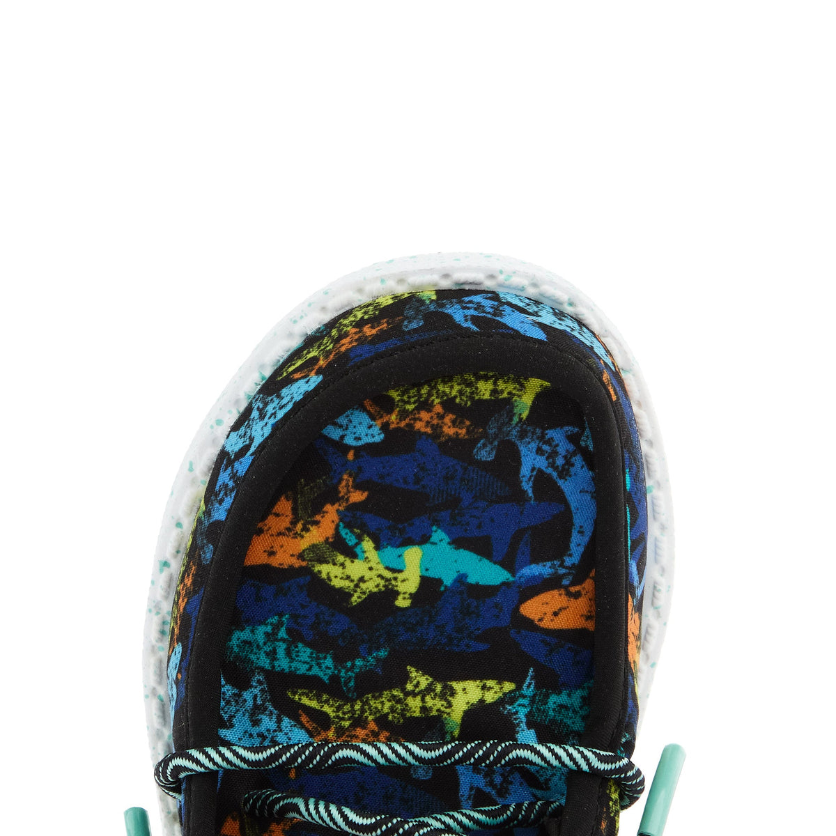 Top-down close-up of boys sneaker toe box featuring colorful shark print pattern