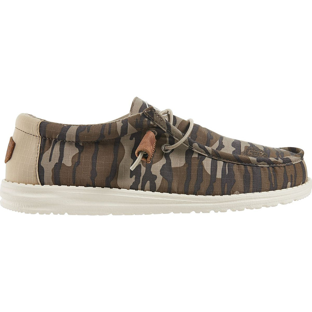 Hey Dude Wally slip-on casual shoe with camouflage canvas upper and white sole, side view