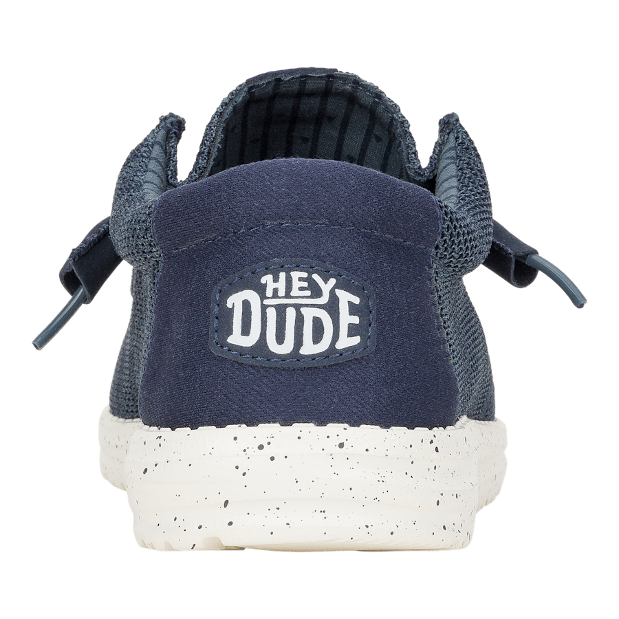 Hey Dude men's slip-on shoe shown from the back with white speckled sole
