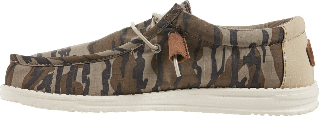 Hey Dude Wally slip-on shoe in camouflage canvas with white sole, side view