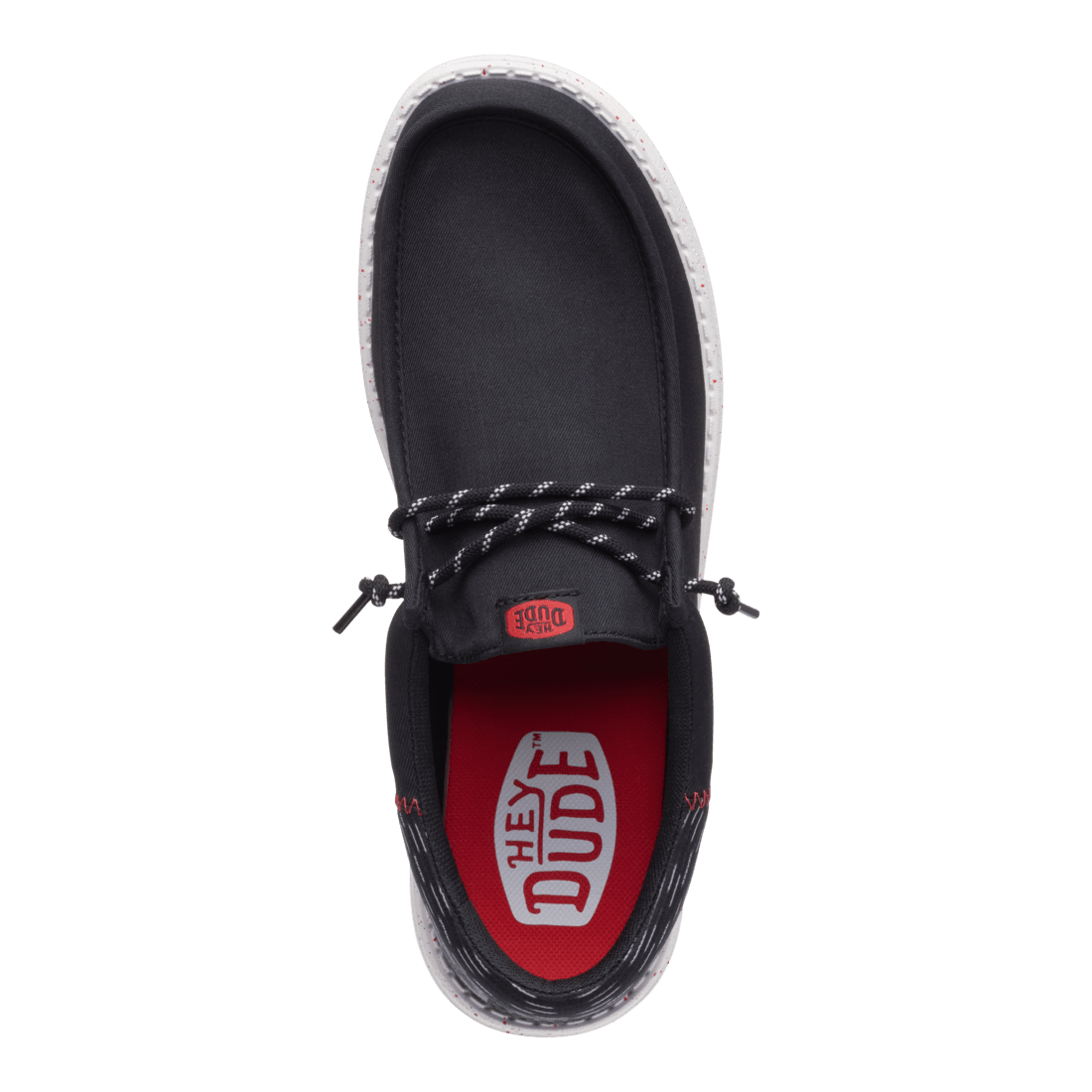 Hey Dude mens slip-on shoe with black canvas upper and red branded insole, top view