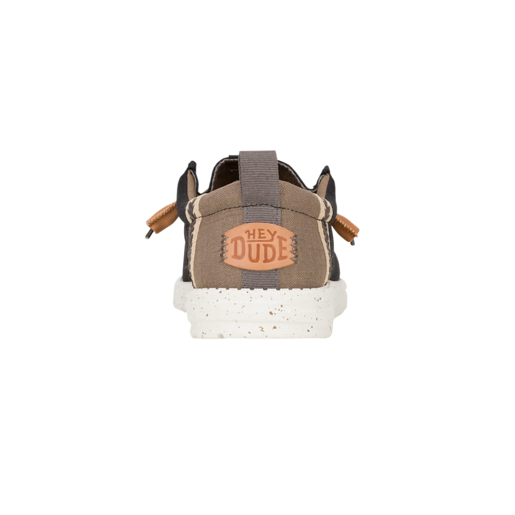 Hey Dude Wally shoe heel view showing brand logo patch and elastic pull tab