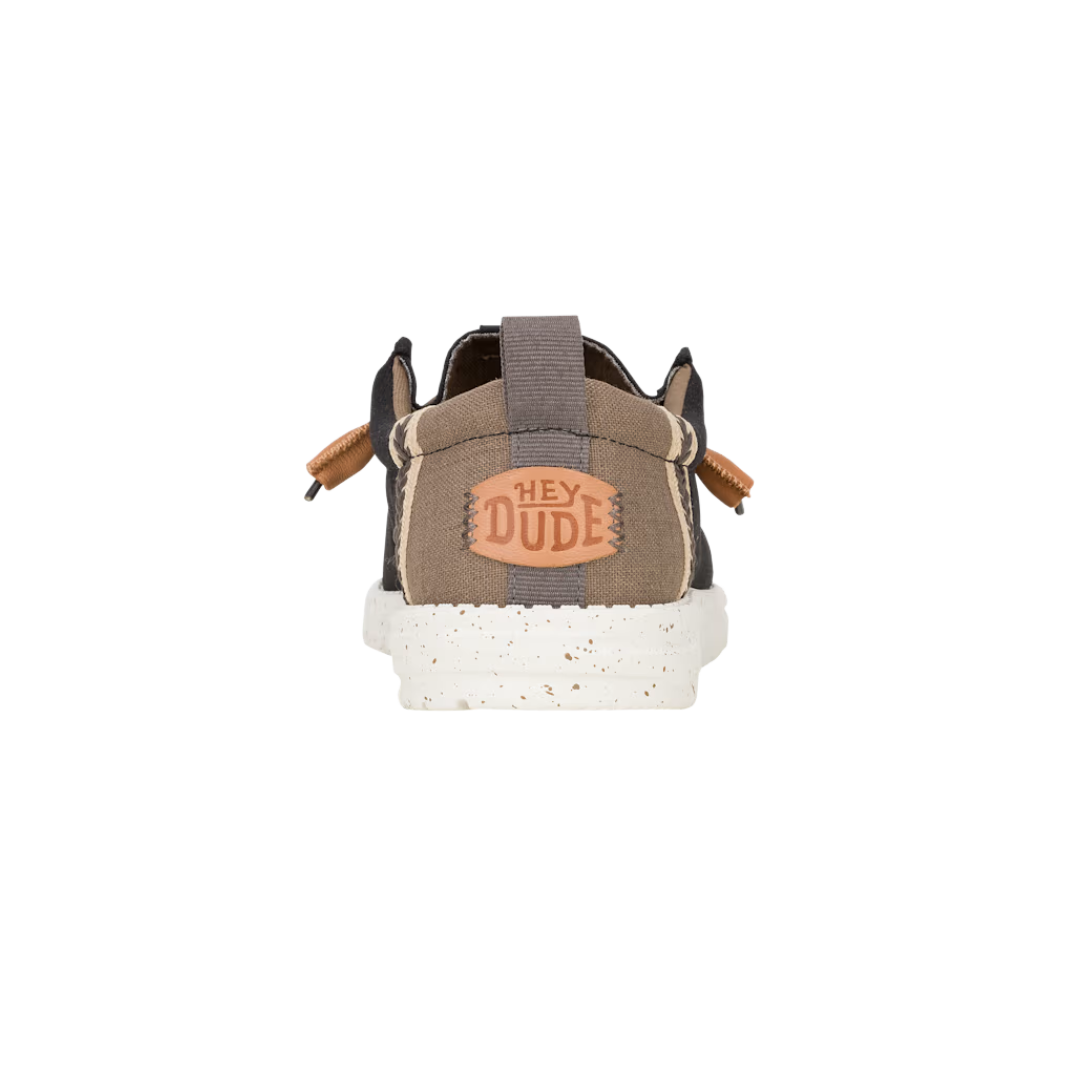 Hey Dude Wally shoe heel view showing brand logo patch and elastic pull tab