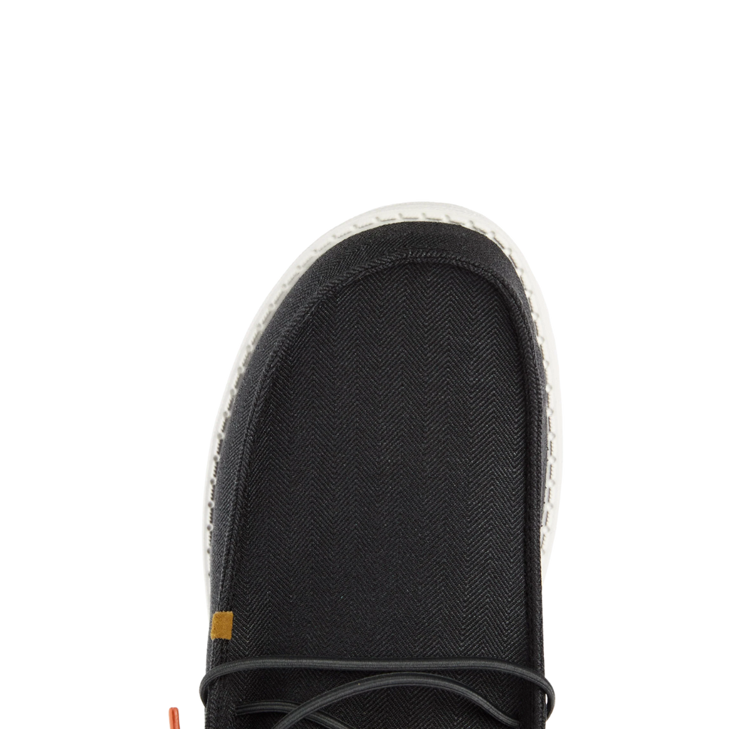 Close-up toe view of men's casual lace-up shoe with herringbone textile upper and white sole