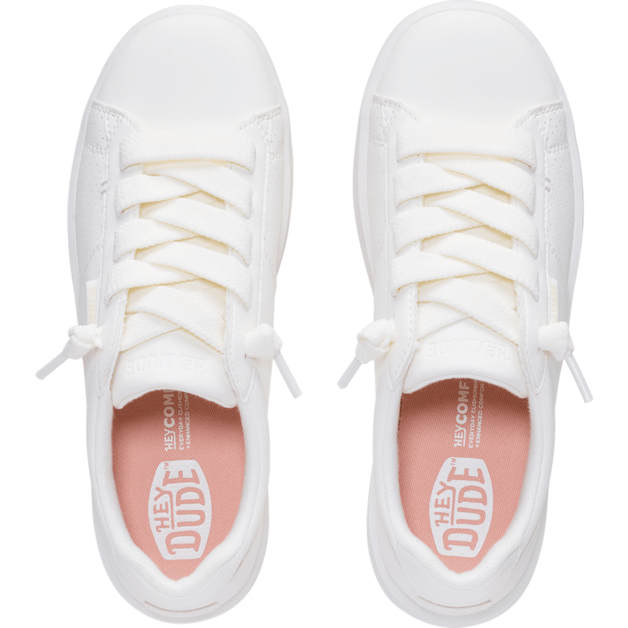 Top-down view of a pair of white lace-up canvas sneakers with pink branded insoles