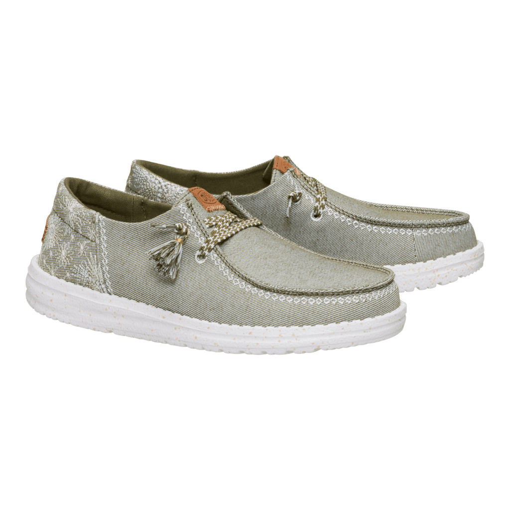 Hey Dude Wendy slip-on shoes with embroidered floral detail and tassel laces, pair angled view