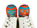 Luchador mask-designed shoe deodorizer inserts placed inside white sneakers, top view