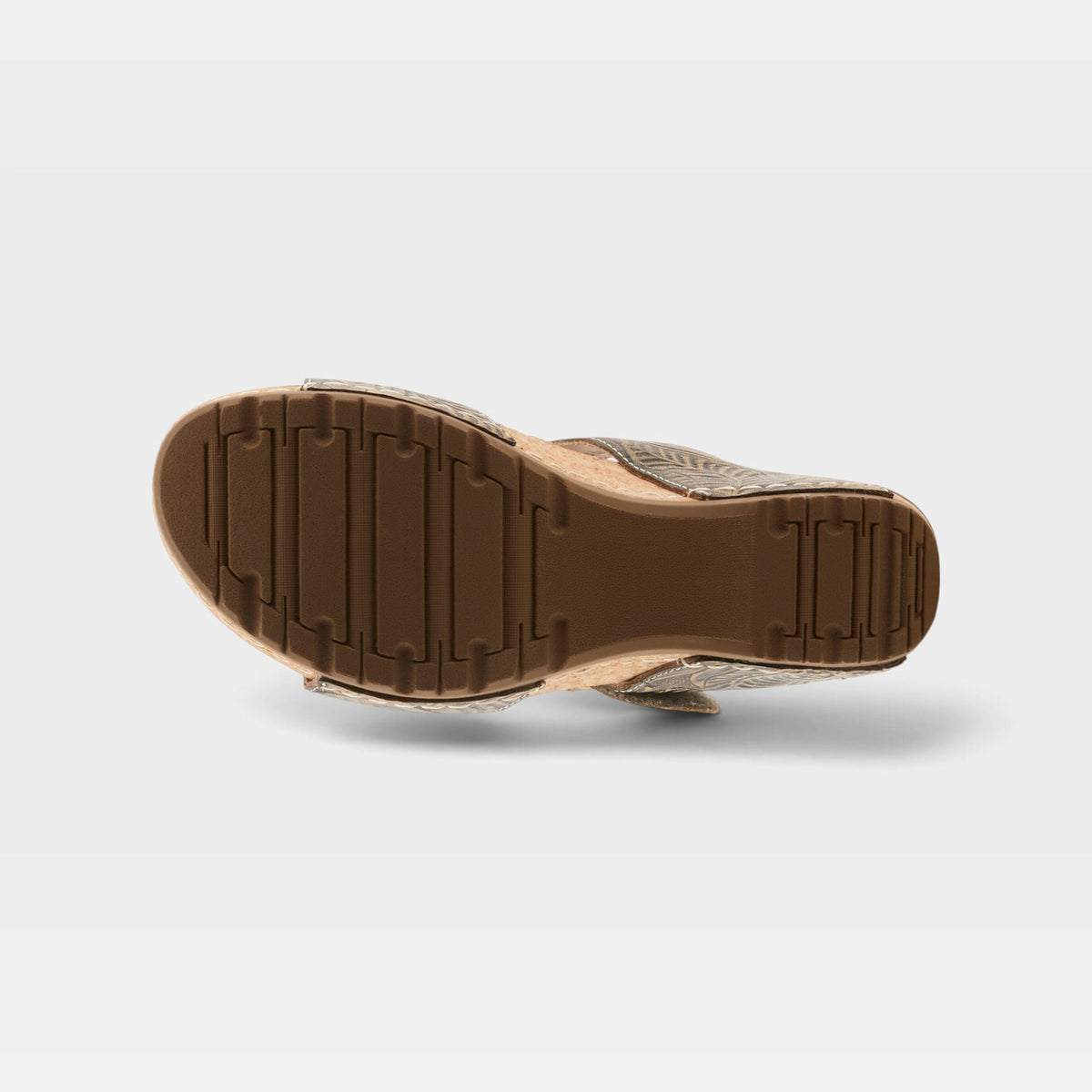 Bottom sole view of womens wedge sandal with treaded rubber outsole and embossed upper