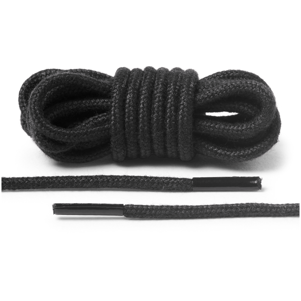 Coiled round shoelaces with aglet tips shown bundled and laid flat on seamless background