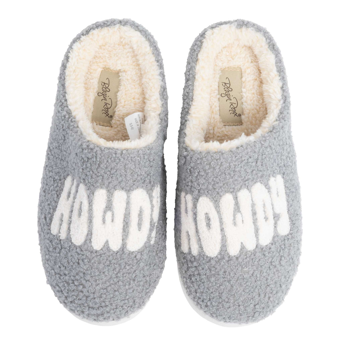 Pair of gray sherpa slippers with white HOWDY lettering and cream fleece lining