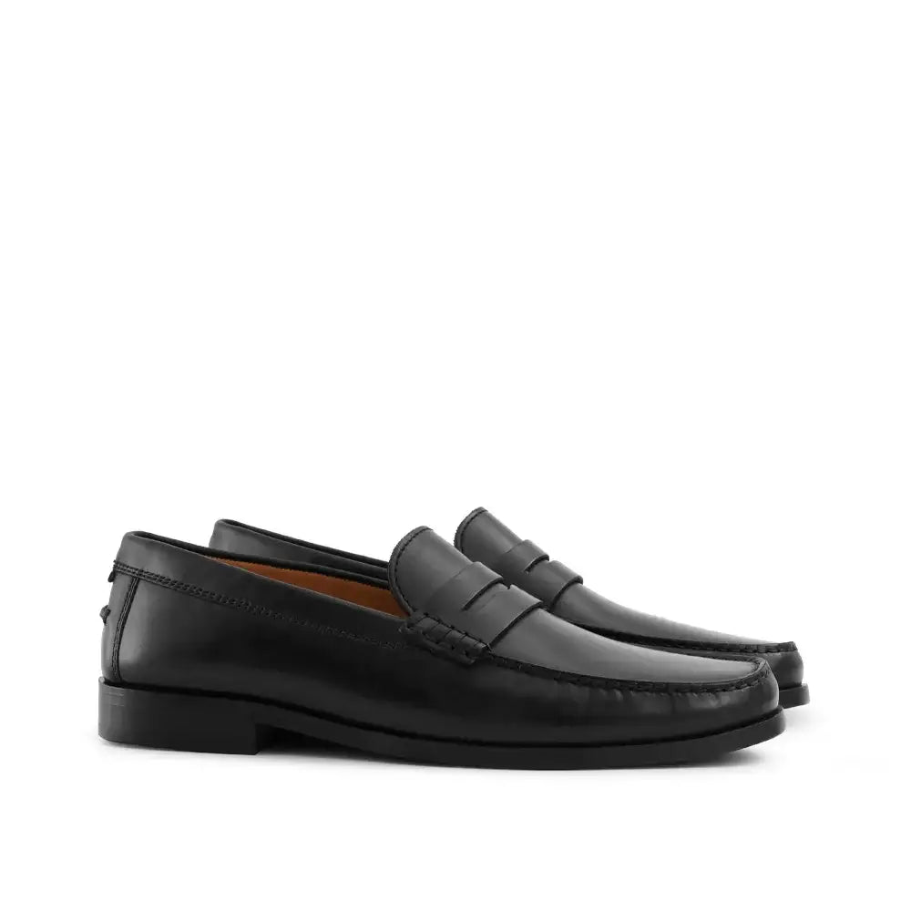 Men's black leather penny loafer with moccasin toe and saddle strap detail
