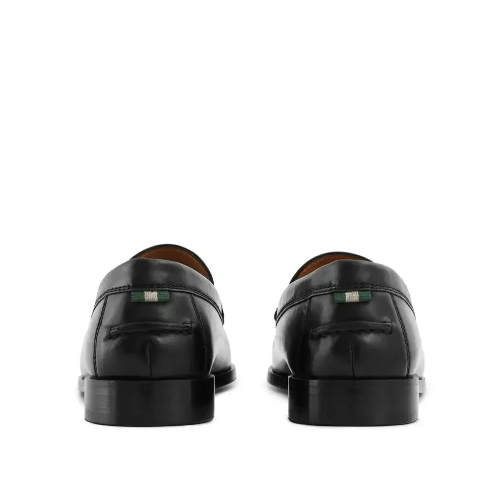 Rear view of mens black leather penny loafers showing heel and brand tab detail