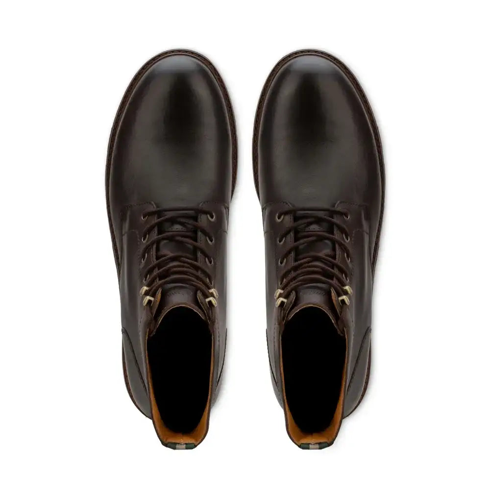 Top-down view of a pair of men's lace-up plain toe leather ankle boots with metal eyelets