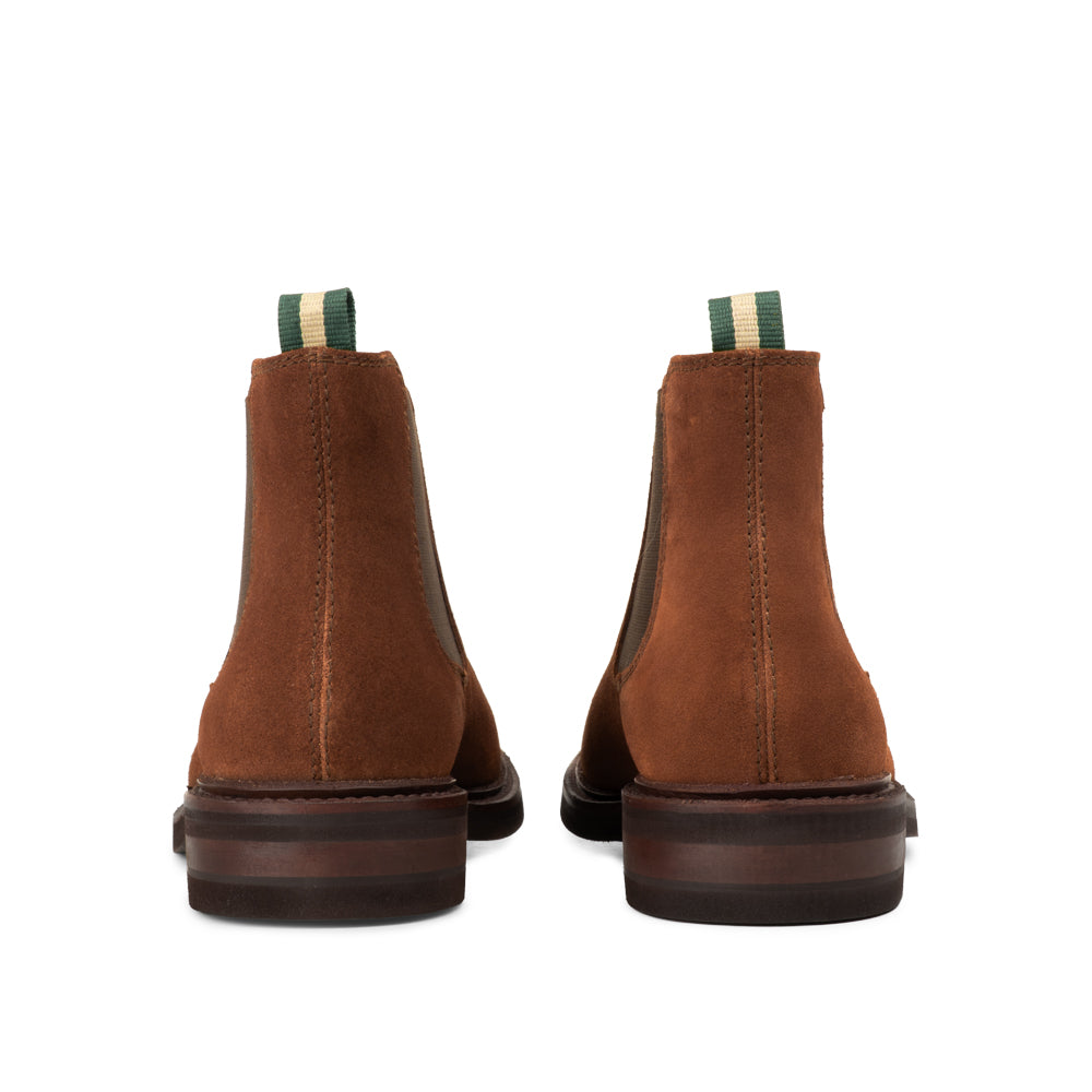 Rear view of men's suede Chelsea boots with green and cream pull tab and dark sole