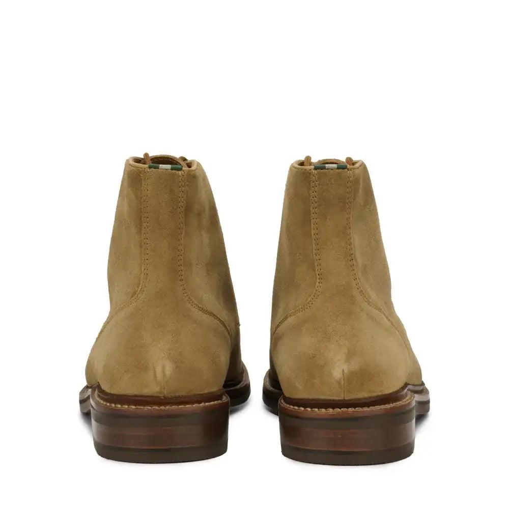 Rear view of men's moc toe ankle boots with dark stacked leather sole and pull tab