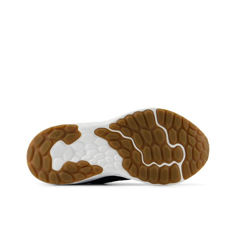 Bottom sole view of New Balance kids running shoe with gum rubber traction pattern