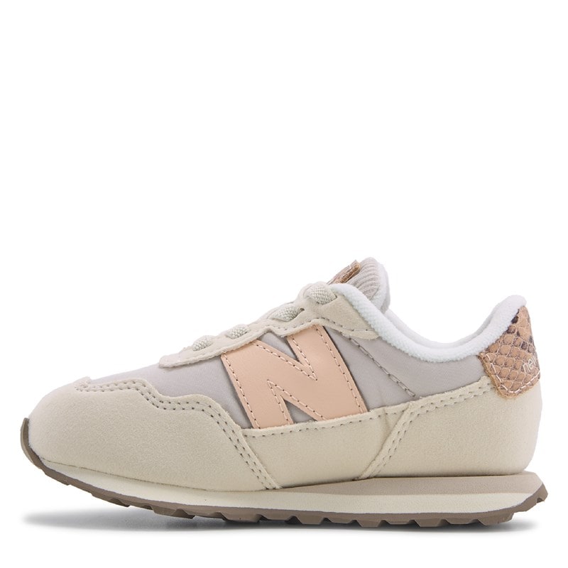 New Balance 237 Bungee toddler sneaker in cream suede with pink N logo, lateral view