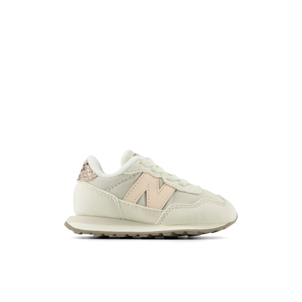 New Balance 237 infant sneaker with pink N logo and glitter heel tab, lateral view