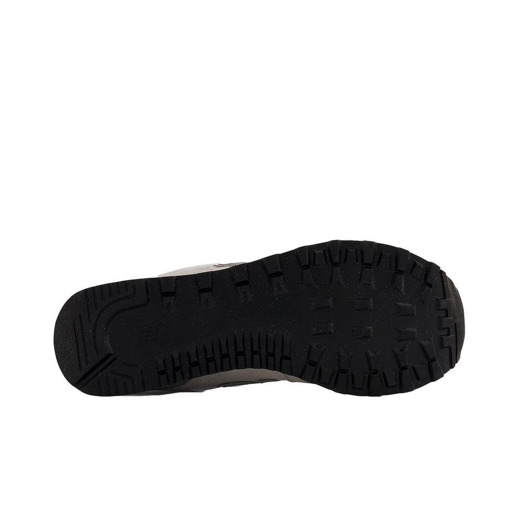 Bottom sole view of New Balance 574 sneaker showing black rubber outsole tread pattern
