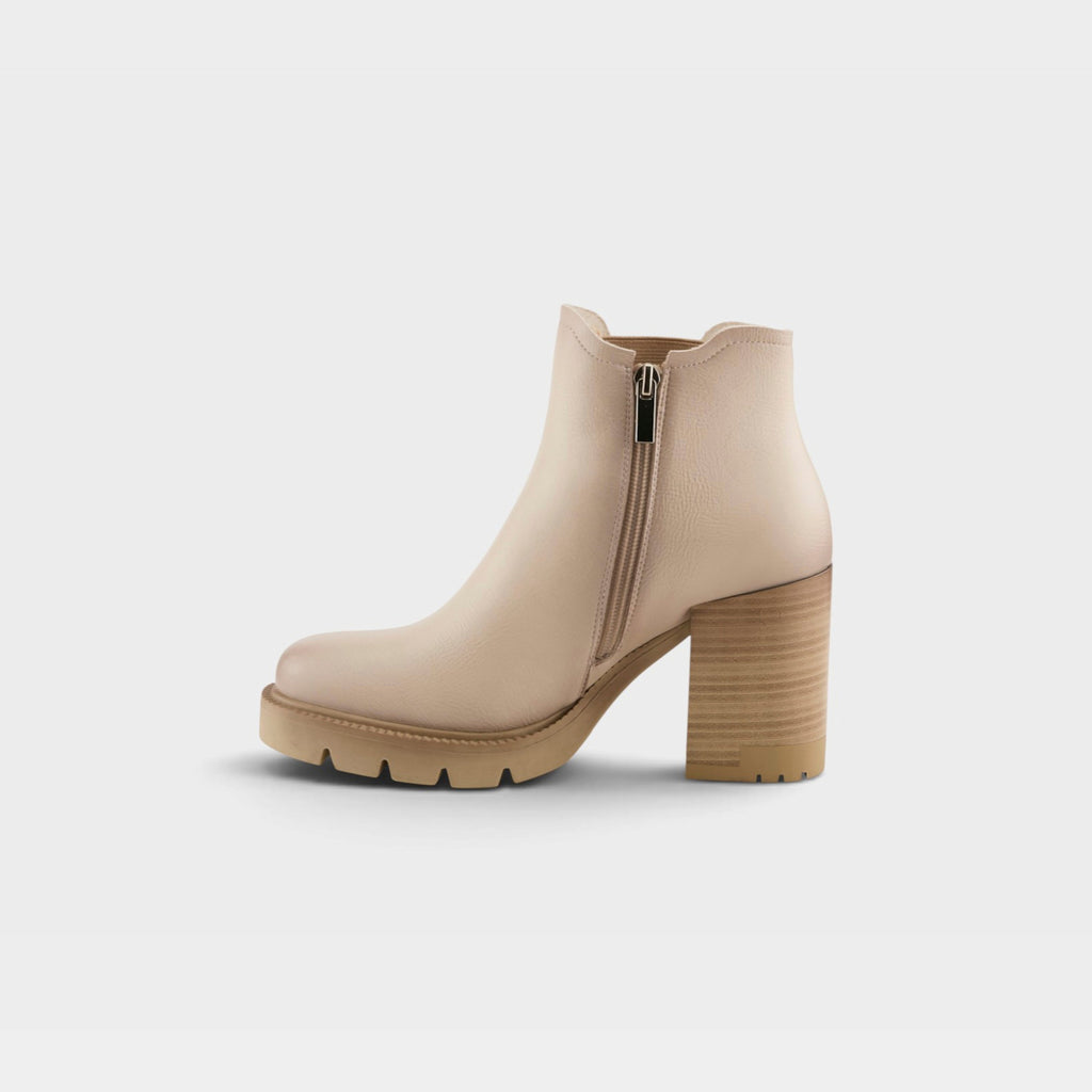 Women's block heel ankle boot with lug sole, side zipper closure, and stacked wooden heel