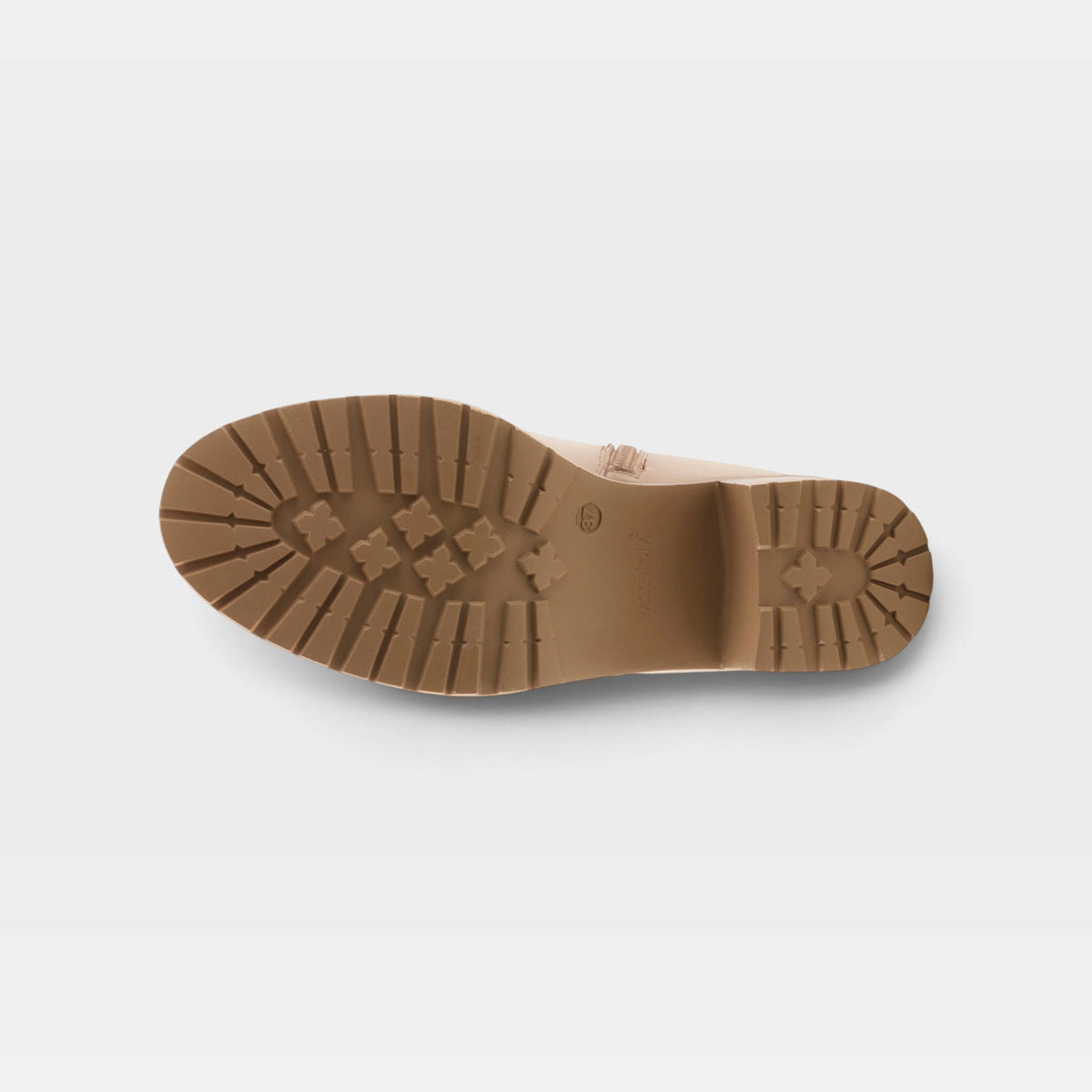 Bottom sole view of a women's boot with lug tread pattern and block heel