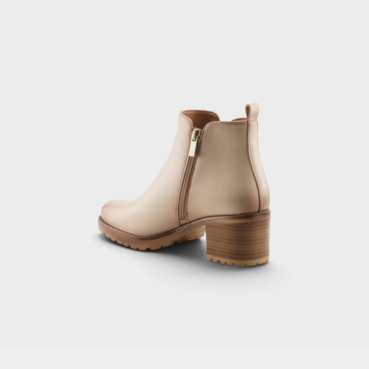 Womens ankle boot with block heel, side zipper, and lug sole shown from rear angle