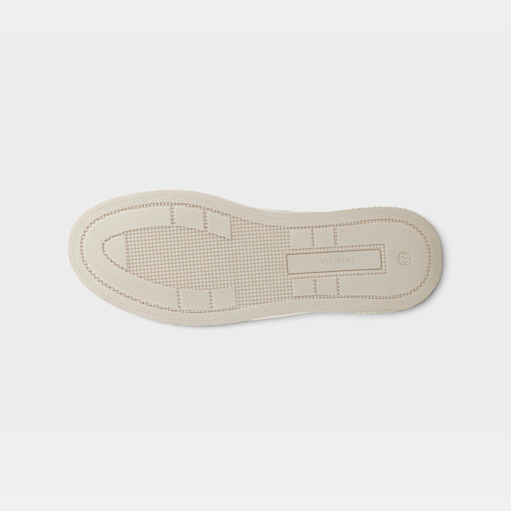 Bottom sole view of a women's sneaker showing tread pattern and brand logo