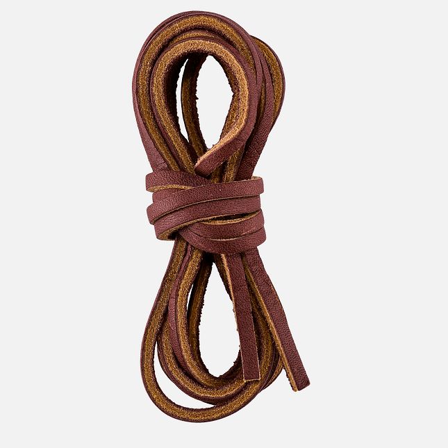Flat leather boot laces coiled and tied in a bundle, showing natural grain texture