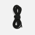 Coiled black round boot laces bundled neatly against a white background