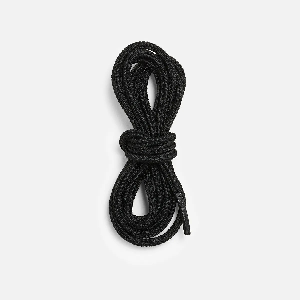 Coiled black round boot laces bundled neatly against a white background
