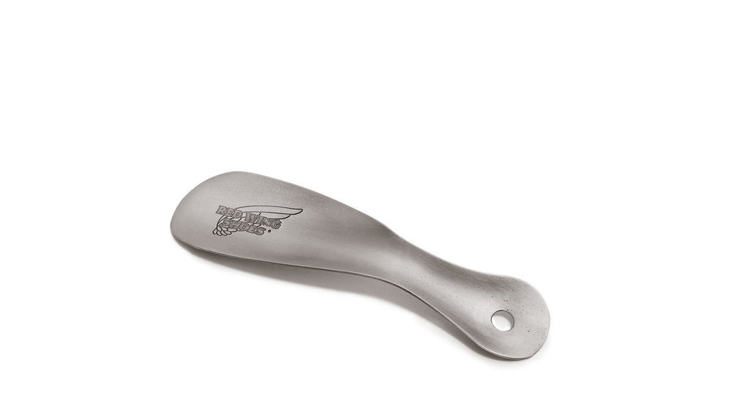 Red Wing metal shoe horn with engraved logo and hanging hole on handle