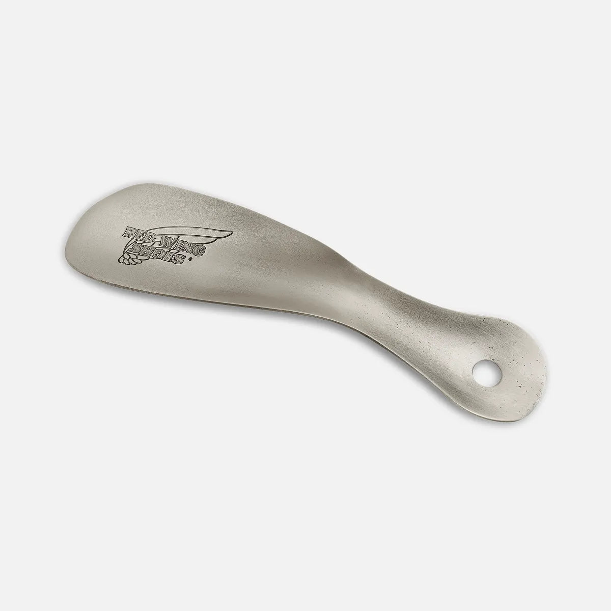 Red Wing metal shoe horn with engraved logo and hanging hole on handle