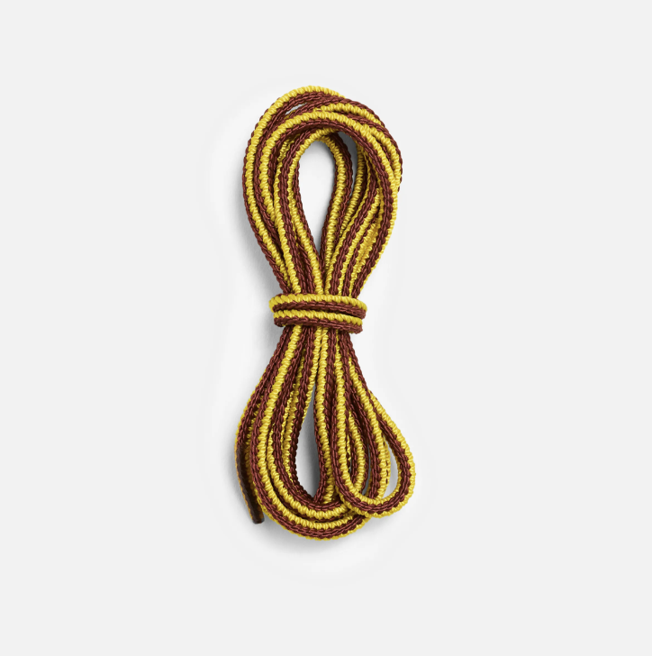 Round waxed boot laces coiled and bundled in a yellow and brown two-tone stripe pattern